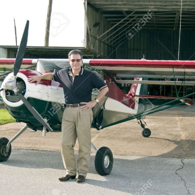 Happy-man-standing-next-to-a-small-single-engine-experimental-plane-in-front-of-its-hanger-just-befo-Stock-Photo Steve Spooner – Corporate Aircraft Sales and Marketing